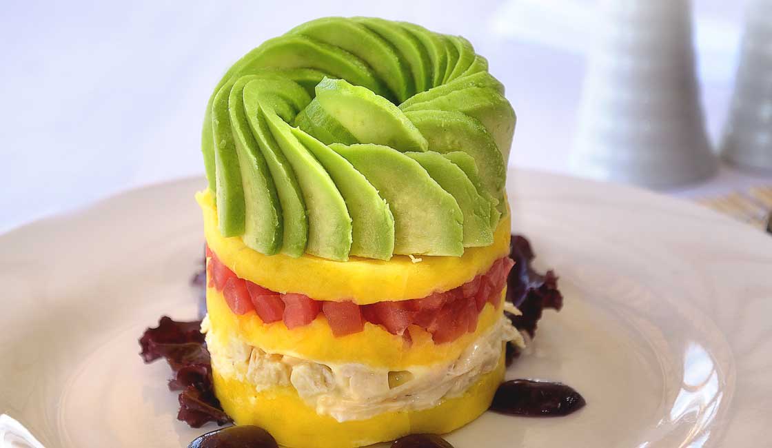 Multilayered savoury cake with avocado on top