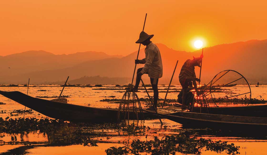 Fisherman with traditional traps at sunset