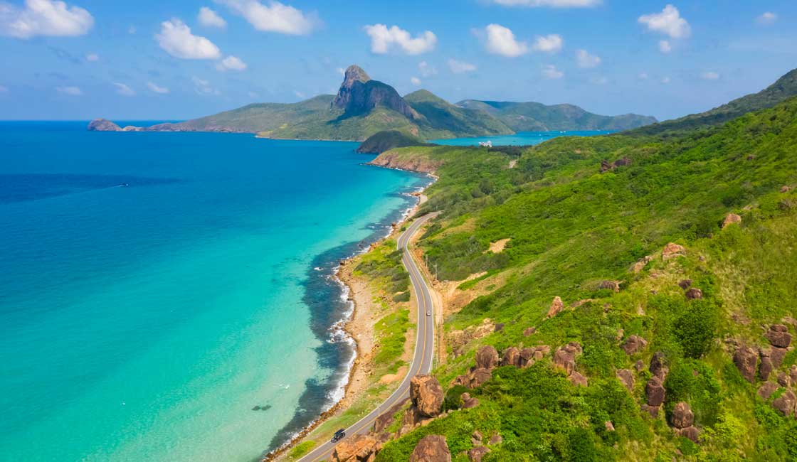 Green island with a beach and a turquoise sea