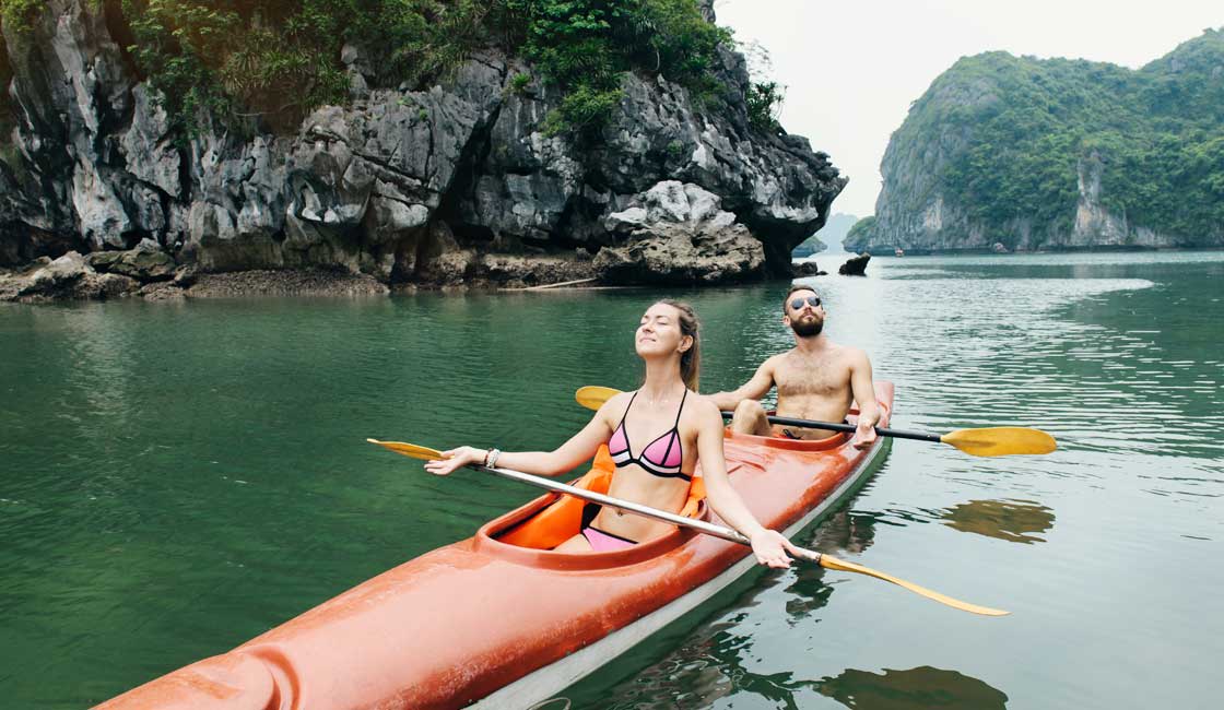 Couple in a kayak in Halong Bay