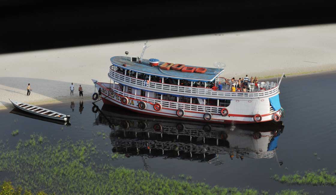 Passenger boat moored at the river bank