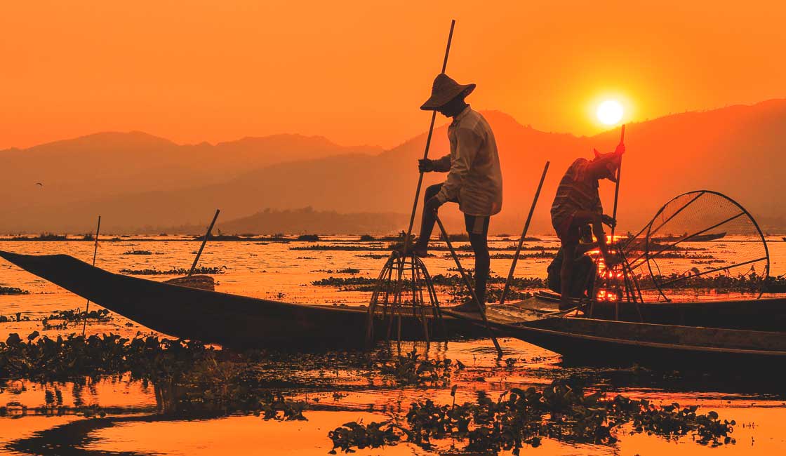 Fishermen on the lake at sunset