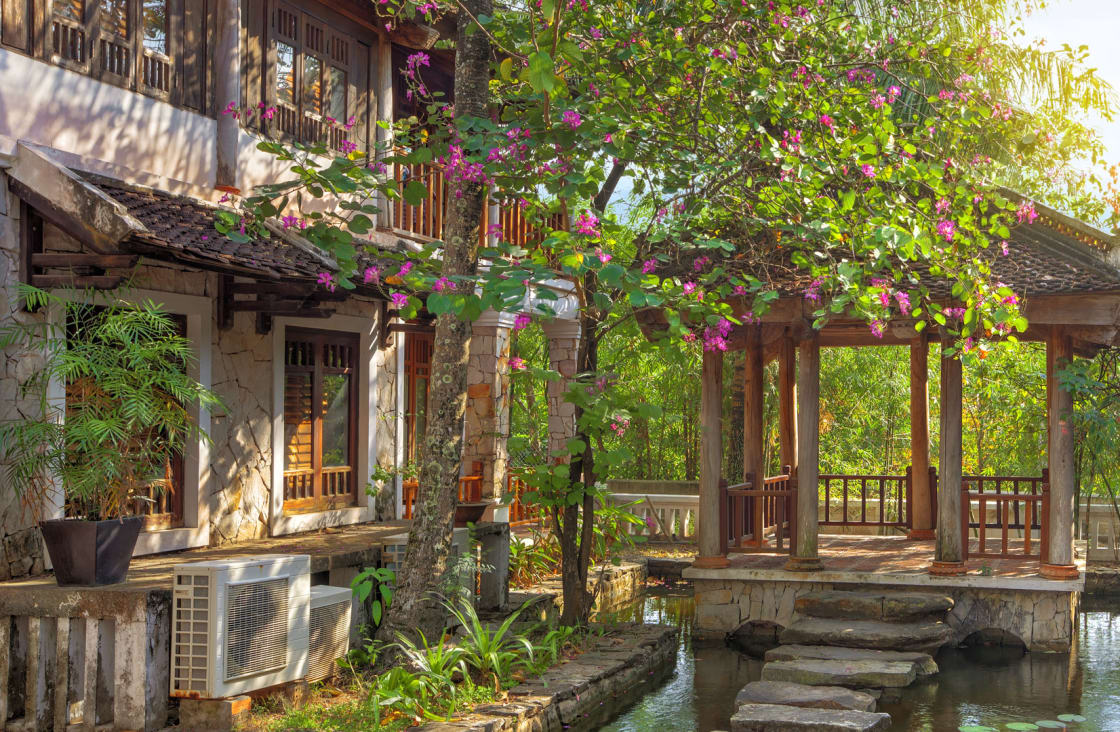 hotel surround by trees and flowers