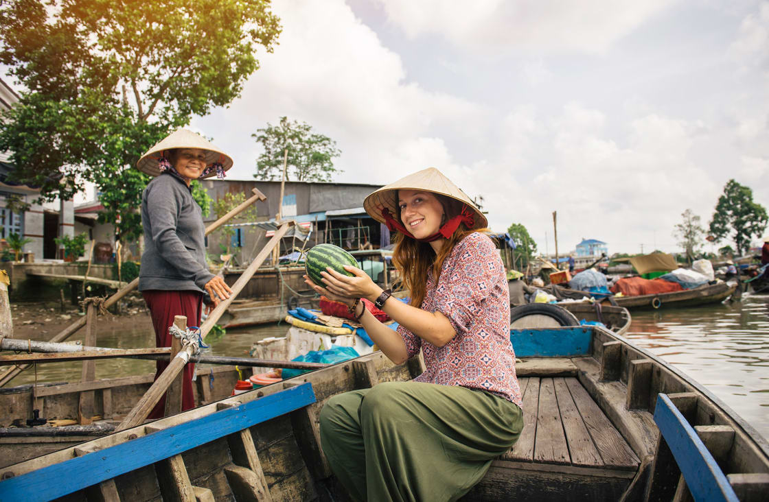 Woman,Tourist,Buying,Fruits,From,The,Boat,On,Cai,Rang