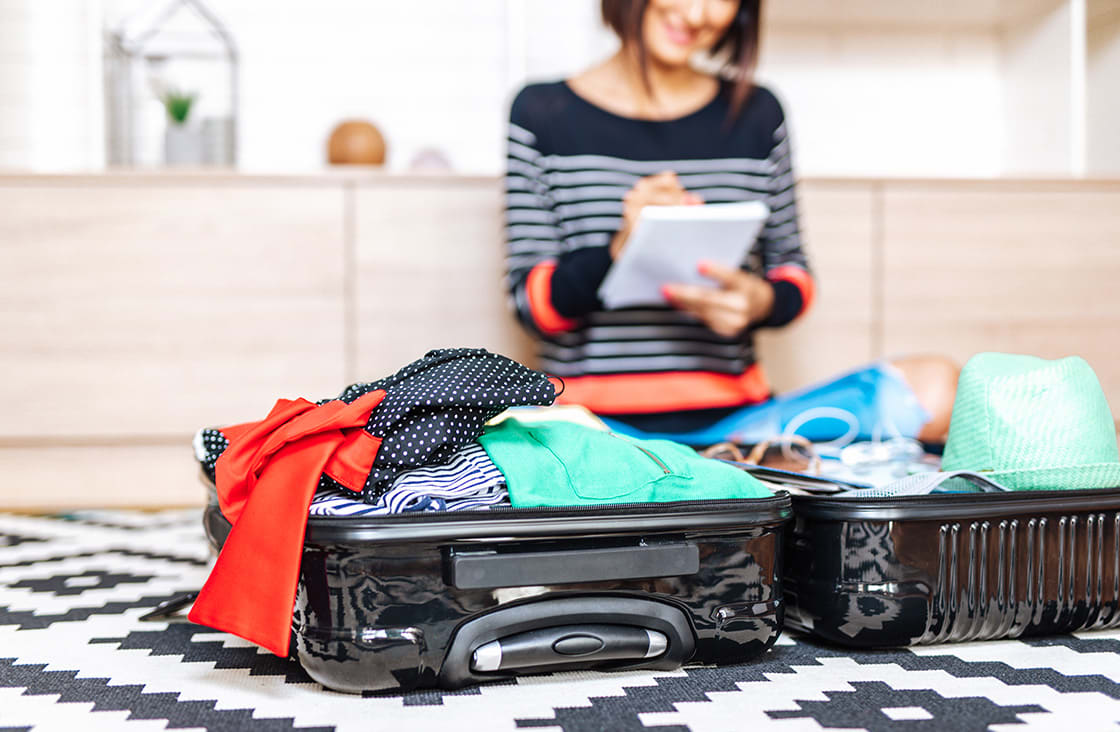 eautiful,Young,Woman,Packing,Her,Stuff,Into,A,Big,Suitcase.