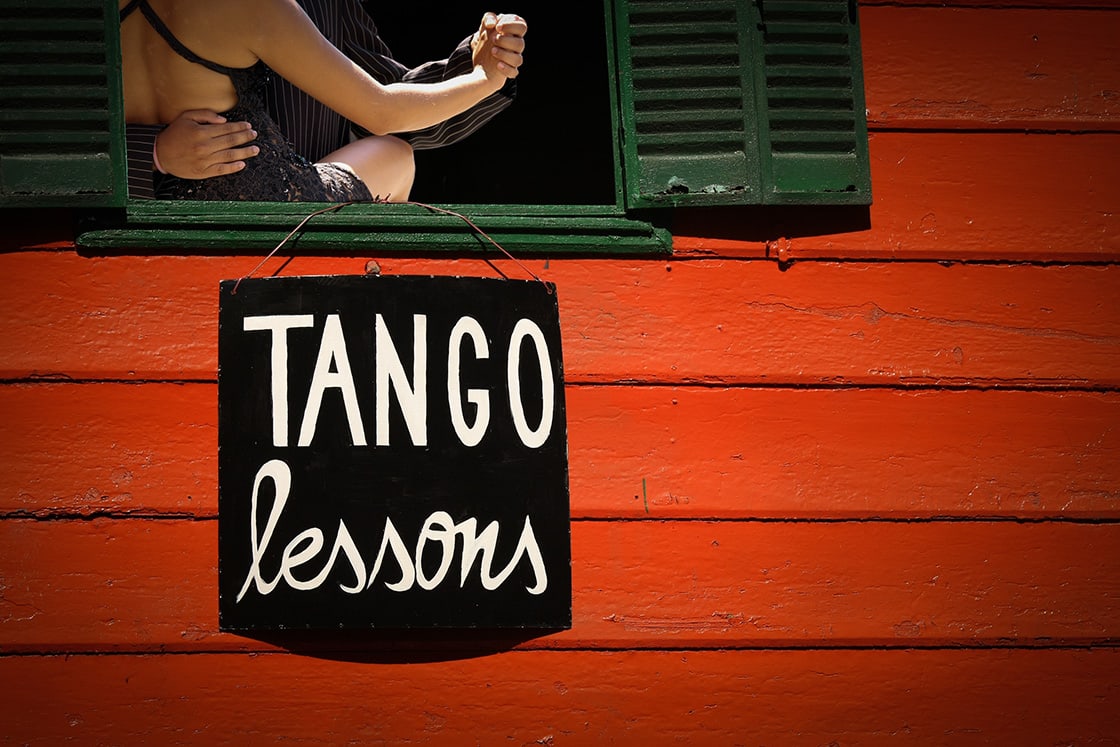 Tango lesson sign and couple dancing