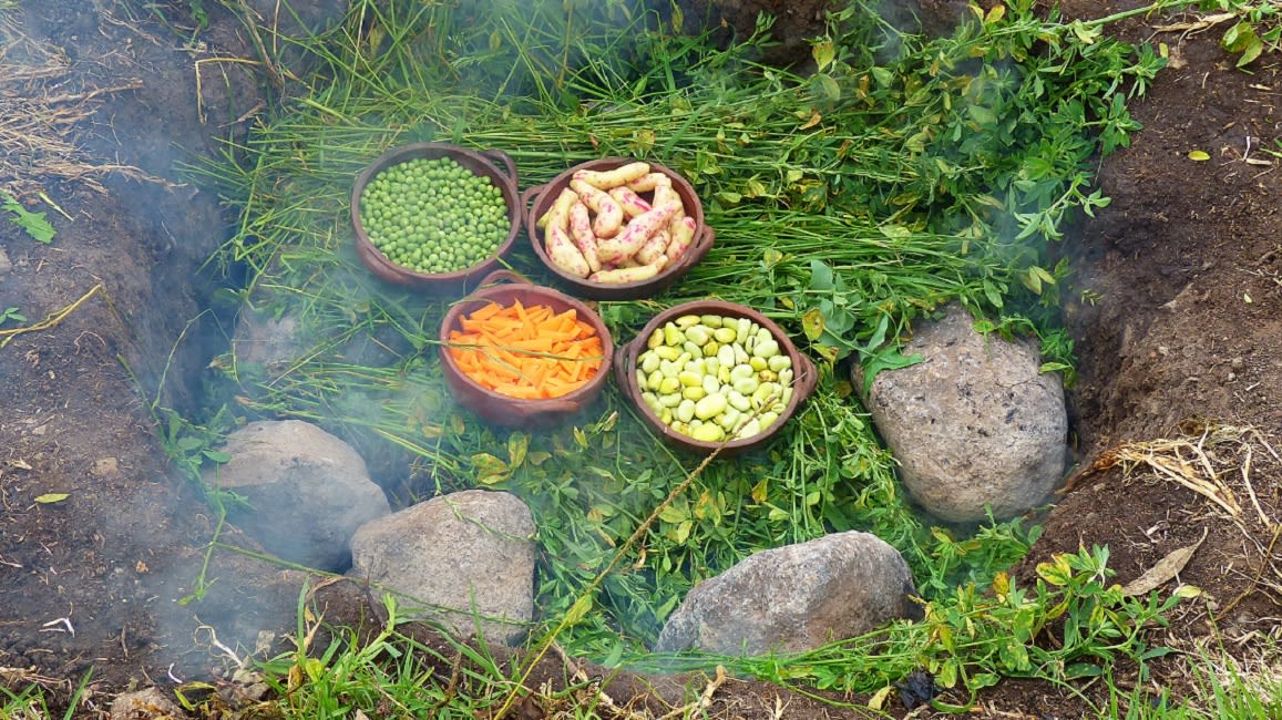 Some Vegetables Being Cooked Over The Underground Oven