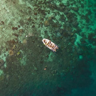 A skiff and clear waters seen from above