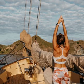 Young woman doing yoga on the deck