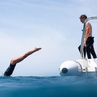 A woman jumping in the ocean