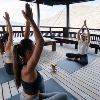 Women doing yoga on the deck