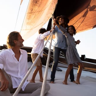 Family posing for photos on bowsprit