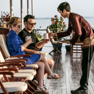 Couple served cocktails on the deck