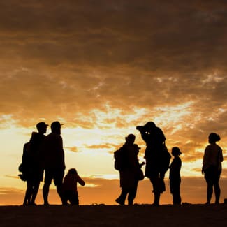 Group watching sunset on the beach