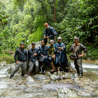 Group of people standing in a river