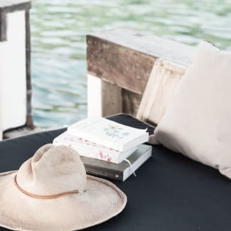 Books and a hat on a ship's sofa