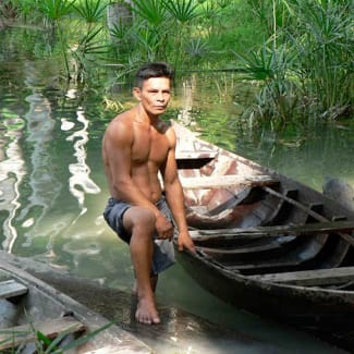 A man and a small wooden boat