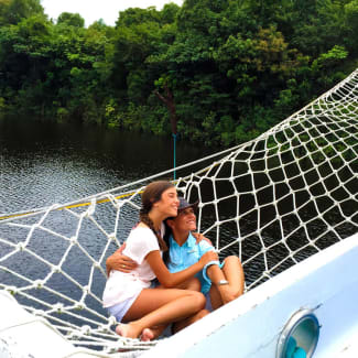 A couple in the hammock onboard