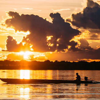 Boat in the Amazon at sunset