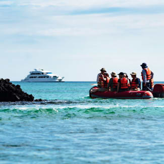 People on the dinghy looking at the ship