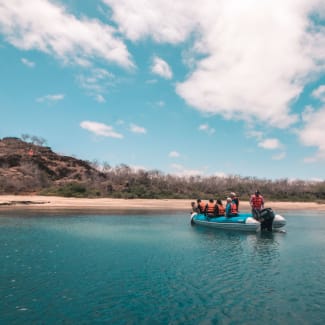 People in the skiff approaching the shore