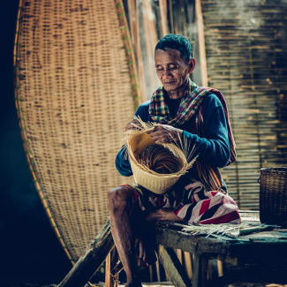 A man weaving a basket