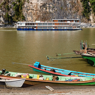 Small boats with the ship in the background