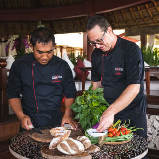 Two chefs preparing plates