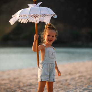 Girl with a sun umbrella on the beach