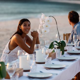 Woman at the table on the beach