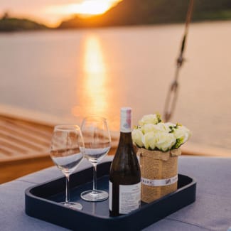 Champagne on the deck at sunset