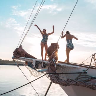 Young people on the bow of the yacht