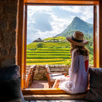 Young woman looking out the window on the mountains