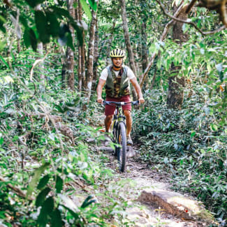 Man on a bicycle in the jungle