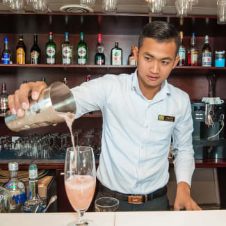 Bartender pouring a cocktail