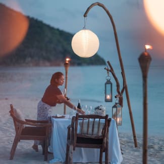 Table on the beach set for dinner