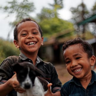 Young Indonesian boys with a dog