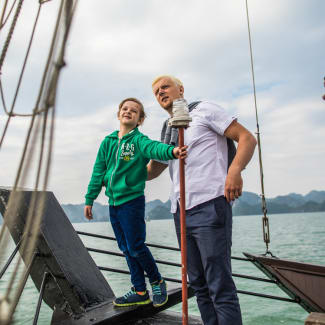 Father and son on the deck in Halong Bay