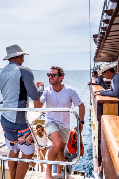 Crew greets guest from excursion