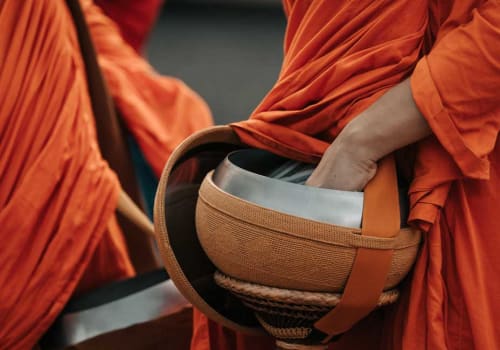 A monk holding a bowl for the alms