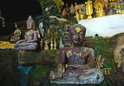 Old Buddha statuette inside the cave