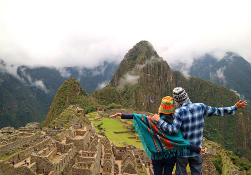 Couple Admiring The Spectacular View Of Machu Picchu