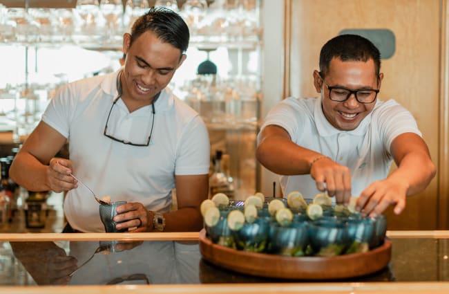 Two smiling bartenders