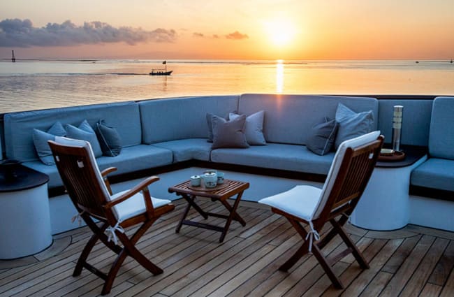 Chairs and sofa on the deck in the sunset light