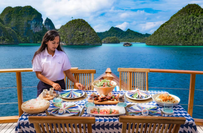 A waiter setting up a table