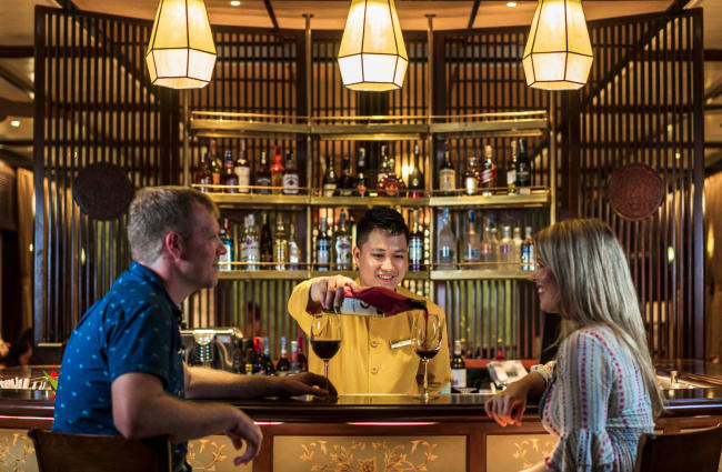 Bartender and a couple by the bar