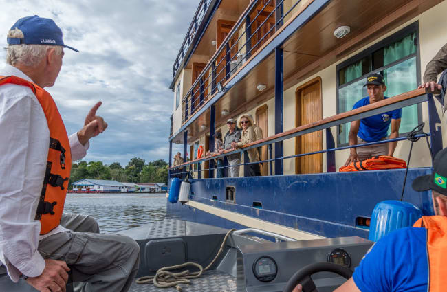 A man arriving to the ship by the speedboat