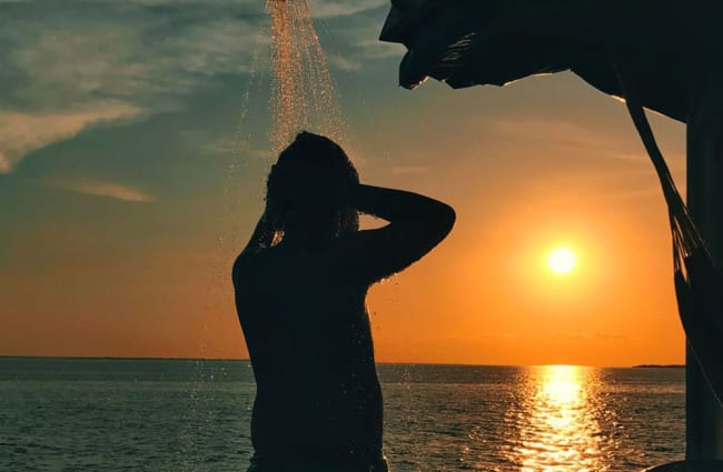 Showering outdoors during sunset