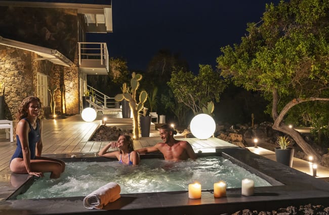 Happy people in the jacuzzi in the evening