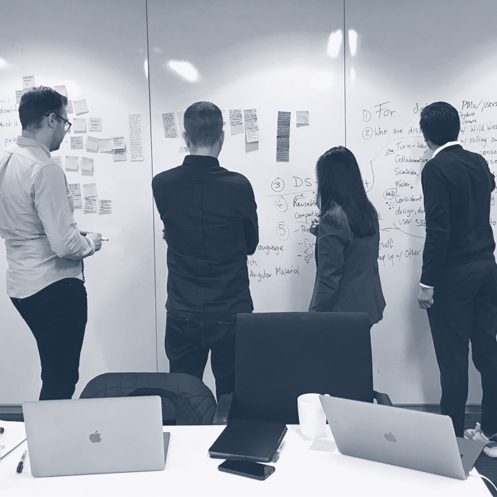 people brainstorming on a whiteboard